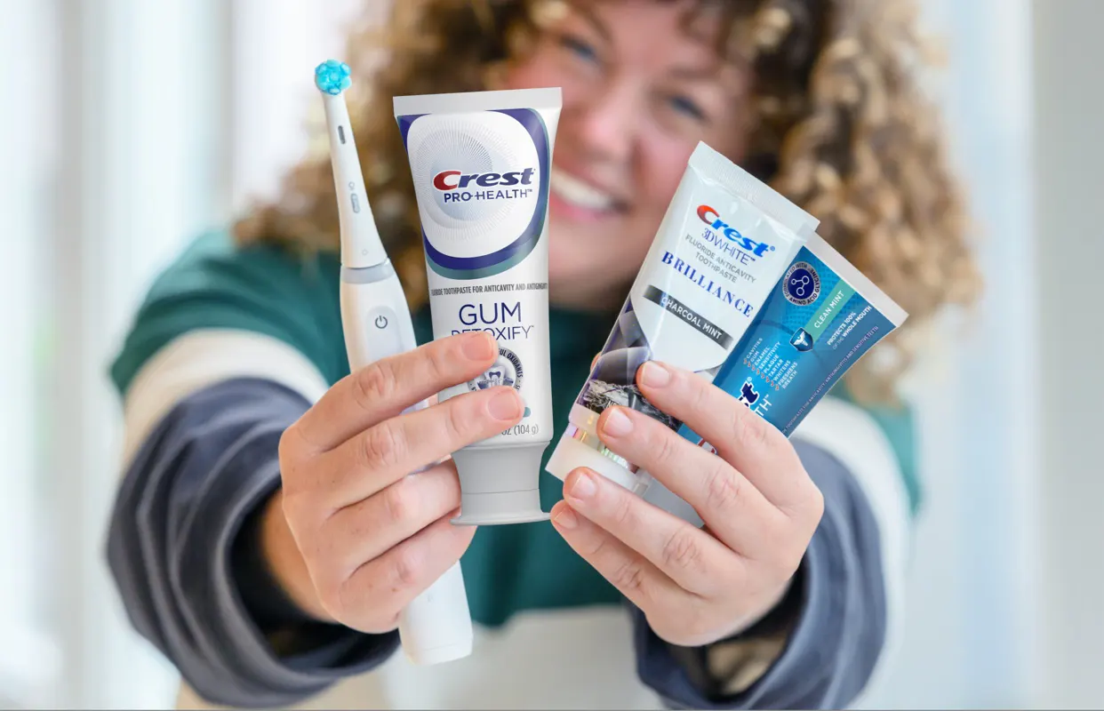 Усмихната жена с продукти на Crest